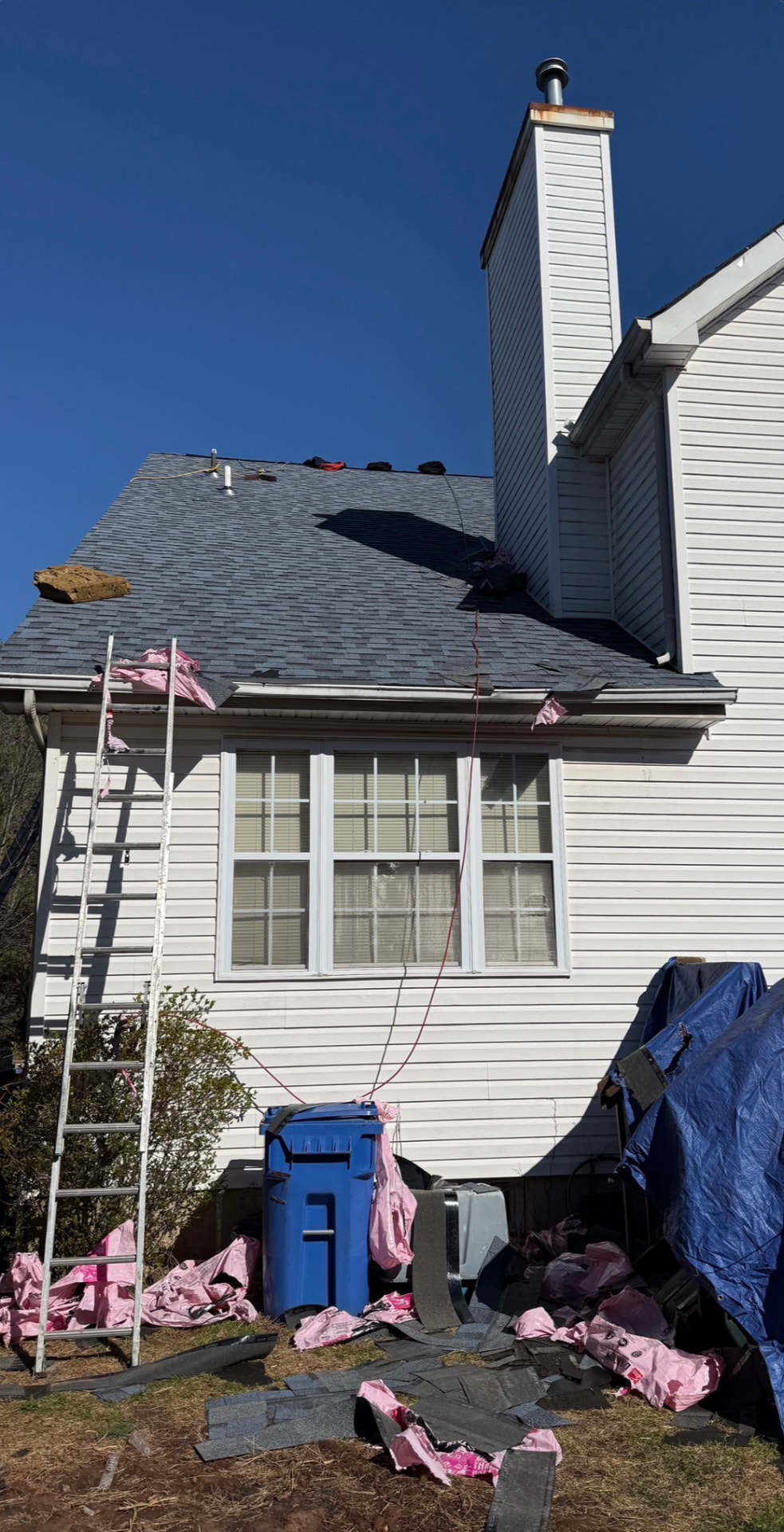 Residential asphalt shingle roof during tear-off