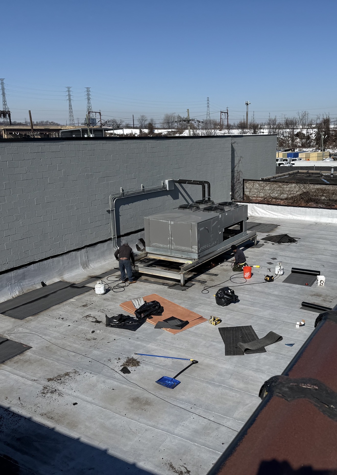 Commercial flat roof repair around a rooftop HVAC unit