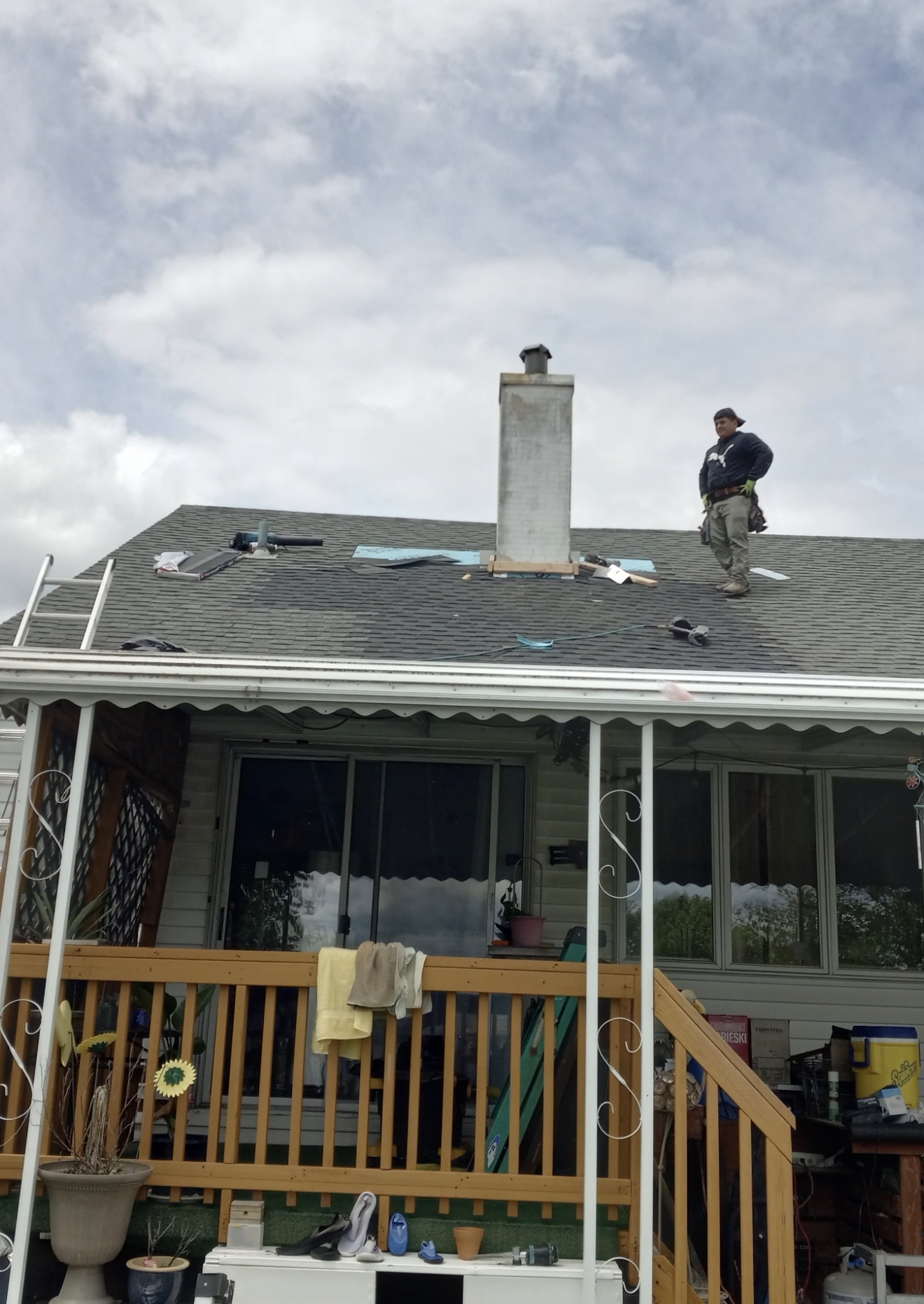 Completed shingle repair around a residential chimney
