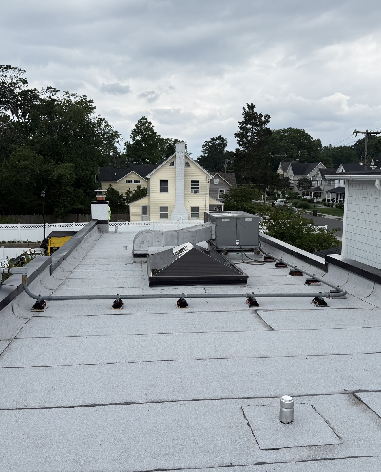 Completed white commercial low-slope roofing system