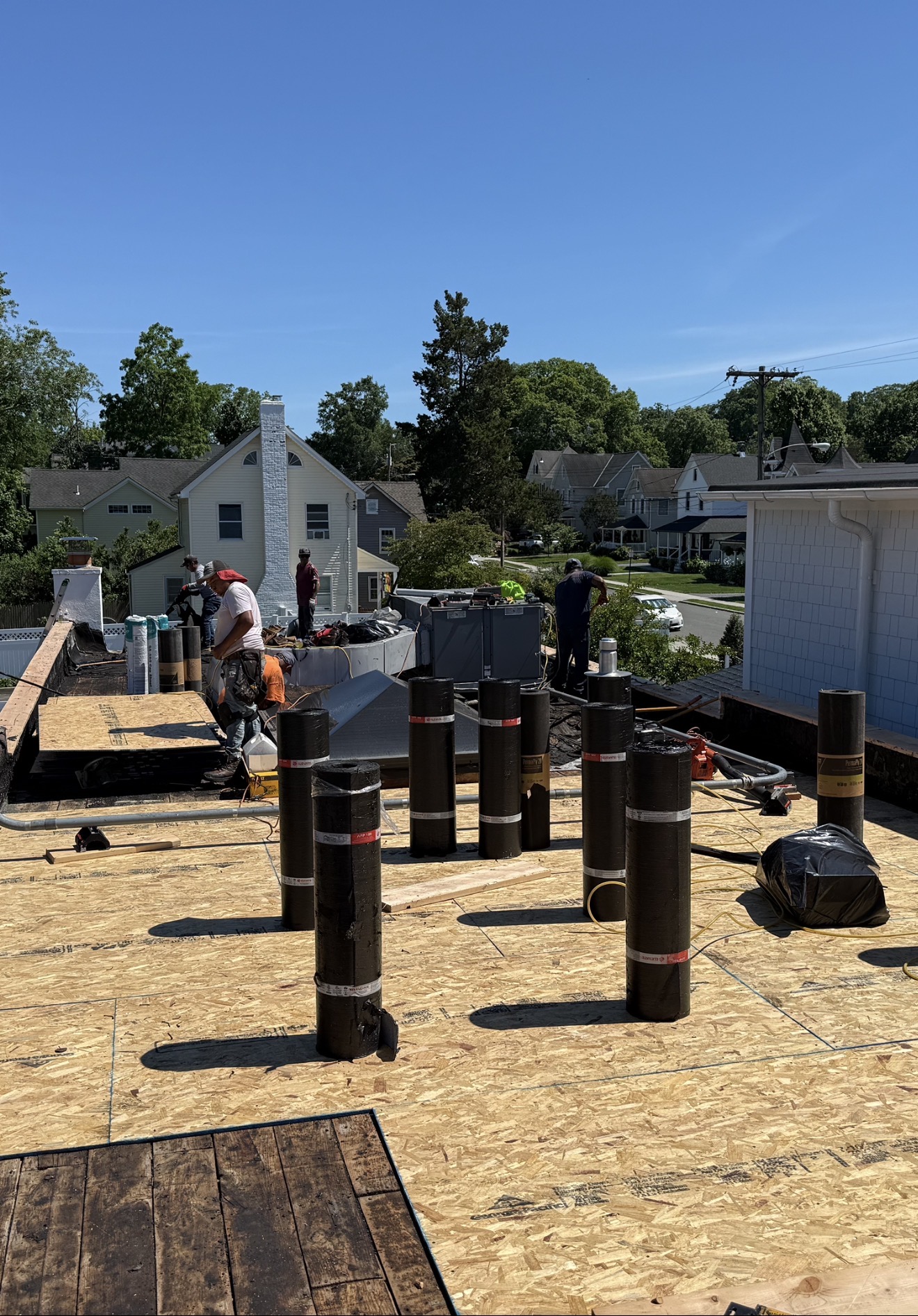 Century Roofing crew rebuilding a commercial low-slope roof