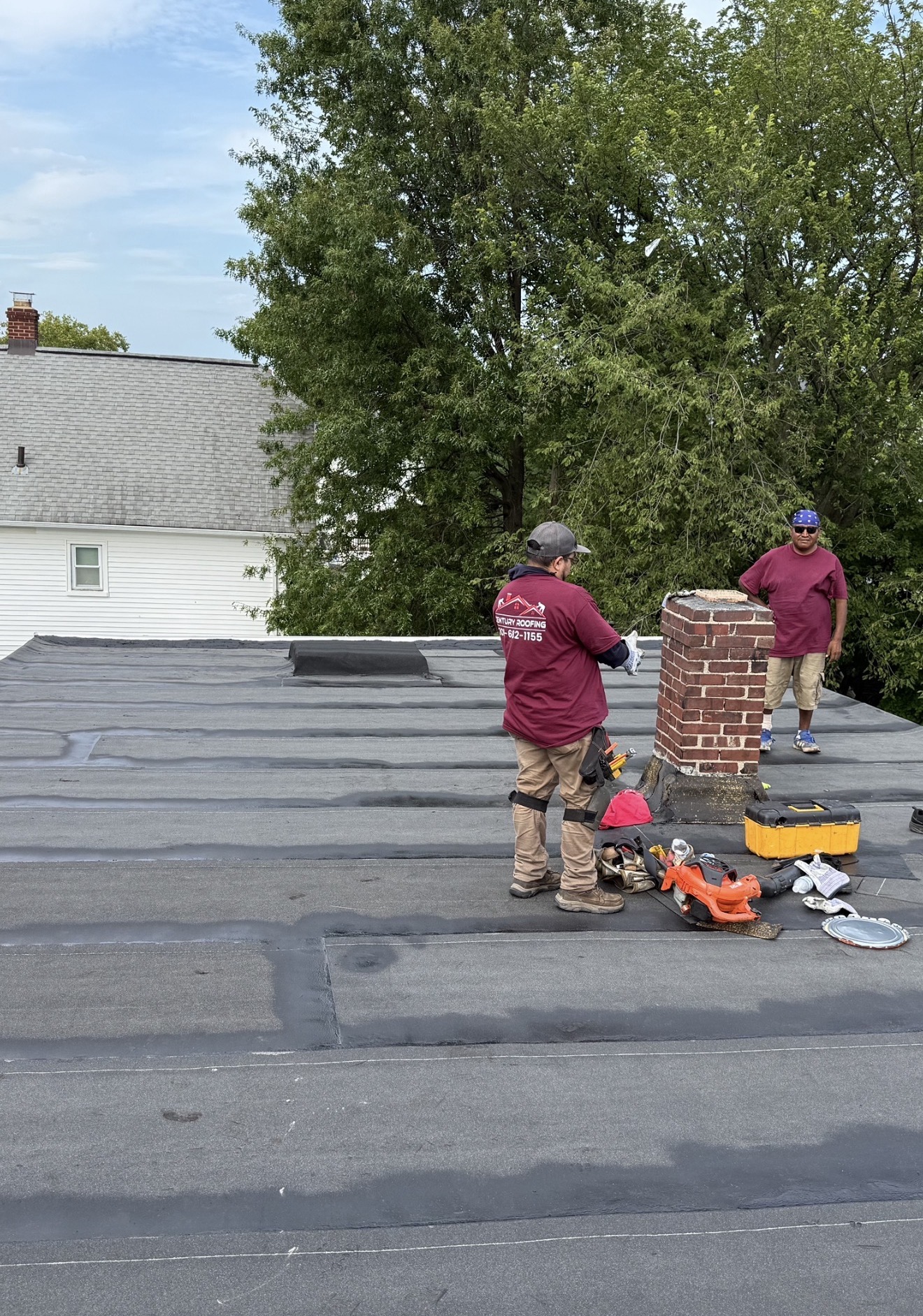 Century Roofing crew installing a modified bitumen flat roof
