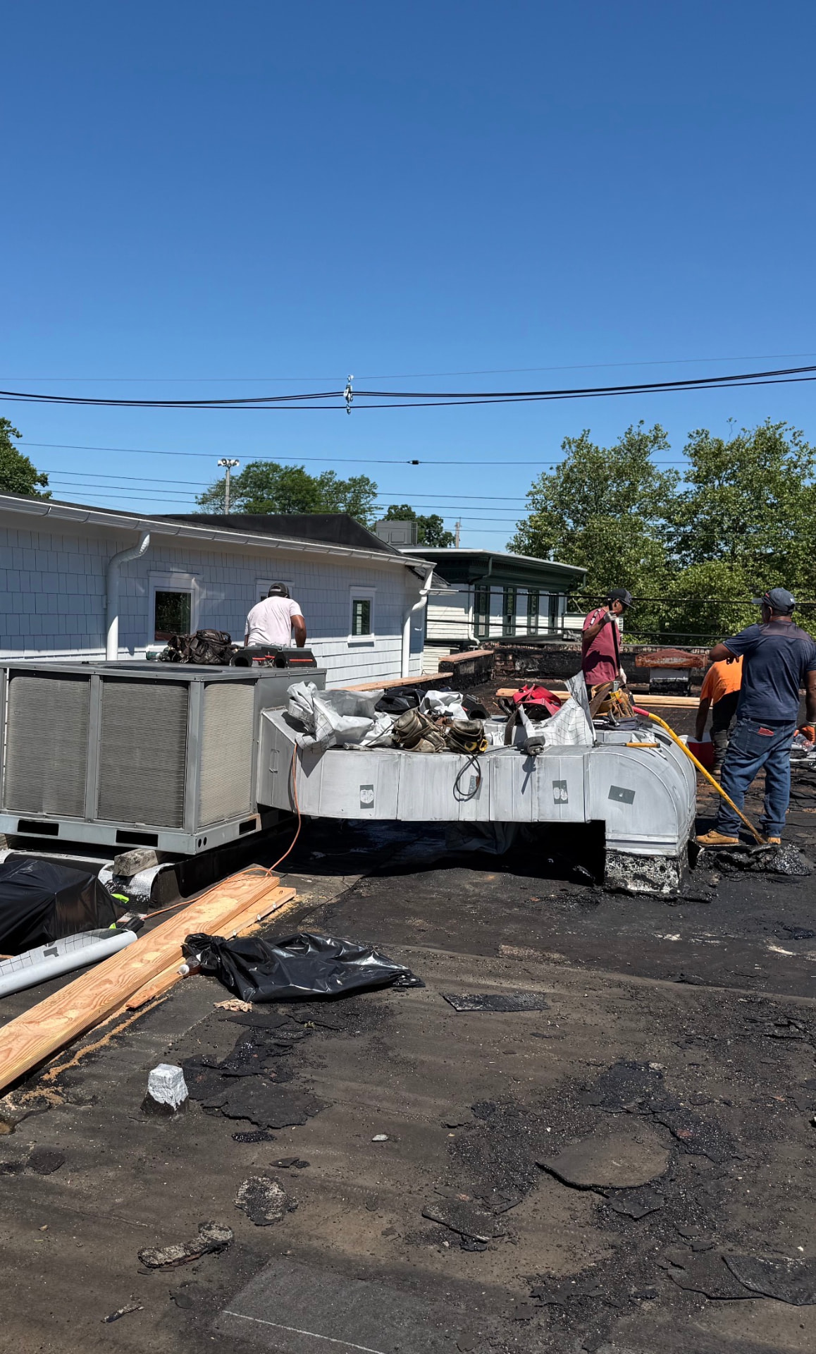 Commercial roof tear-off around HVAC ductwork
